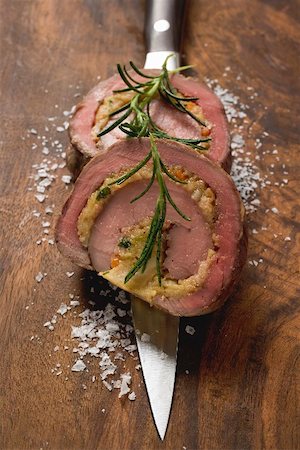 Two slices of stuffed beef roulade with rosemary Stock Photo - Premium Royalty-Free, Code: 659-01864686