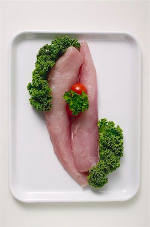 simsearch:659-01862764,k - Two pieces of pork loin with garnish Foto de stock - Royalty Free Premium, Número: 659-01864691