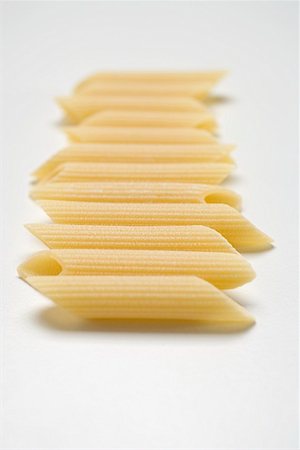 simsearch:659-01864821,k - Several penne in a row Fotografie stock - Premium Royalty-Free, Codice: 659-01864822