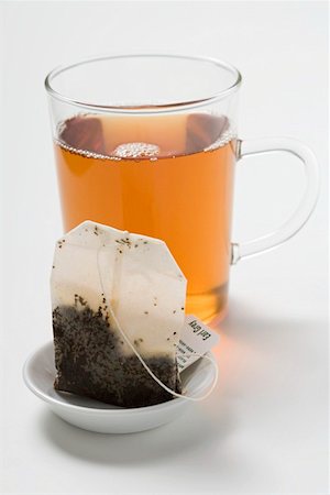 Earl Grey tea in glass cup, tea bag in foreground Stock Photo - Premium Royalty-Free, Code: 659-01865132