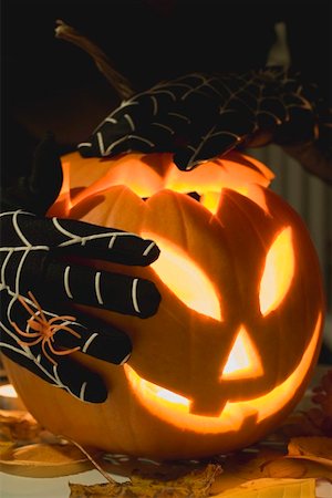 simsearch:659-01864379,k - Hands in cobweb gloves holding pumpkin lantern Stock Photo - Premium Royalty-Free, Code: 659-01865165