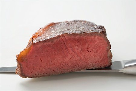 steak knife - Beef steak, showing cut edge, on knife Stock Photo - Premium Royalty-Free, Code: 659-01865239