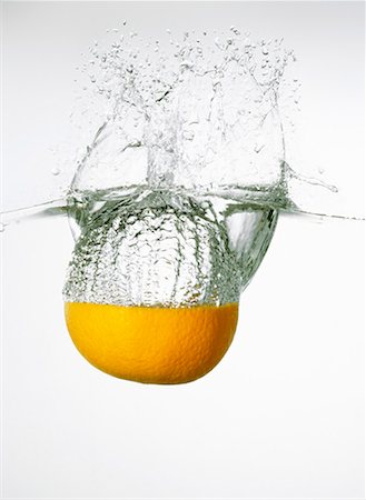 Orange falling into water Stock Photo - Premium Royalty-Free, Code: 659-01865315