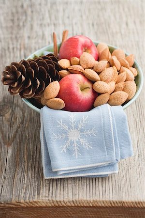 simsearch:659-03524584,k - Red apples, almonds and cone in bowl on wooden table Stock Photo - Premium Royalty-Free, Code: 659-01865344