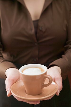 simsearch:659-08896141,k - Woman holding cup of cappuccino Fotografie stock - Premium Royalty-Free, Codice: 659-01865398