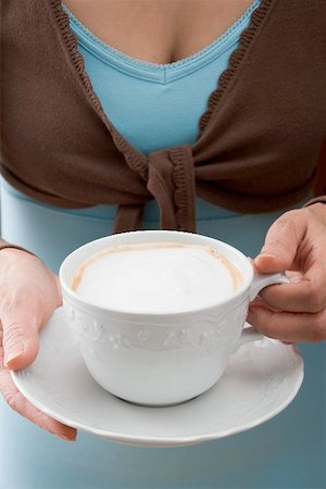 simsearch:659-07026887,k - Woman holding cup of cappuccino Foto de stock - Sin royalties Premium, Código: 659-01865393