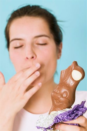 Woman holding chocolate Easter Bunny with a bite taken Foto de stock - Sin royalties Premium, Código: 659-01865514