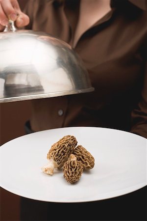simsearch:659-02212906,k - Woman serving fresh morels on plate with dome cover Stock Photo - Premium Royalty-Free, Code: 659-01865625