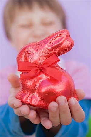 foil chocolate bunnies - Child holding red Easter Bunny Stock Photo - Premium Royalty-Free, Code: 659-01865787