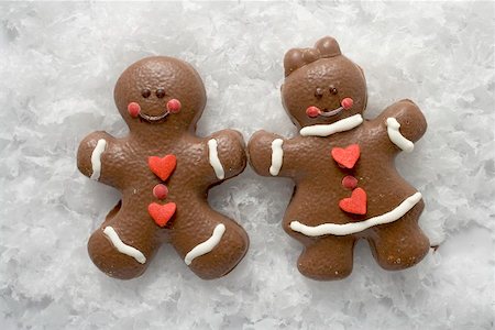 Two Christmassy chocolate-coated gingerbread people in snow Stock Photo - Premium Royalty-Free, Code: 659-01865883