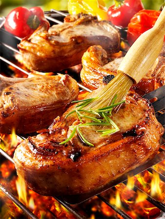 porkchop - Brushing pork chop on barbecue rack with oil Stock Photo - Premium Royalty-Free, Code: 659-01866063
