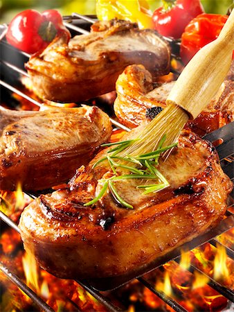 pork chops not raw - Brushing pork chop on barbecue rack with oil Stock Photo - Premium Royalty-Free, Code: 659-01866063