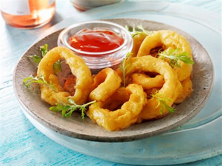 Battered deep-fried onion rings with ketchup Stock Photo - Premium Royalty-Free, Code: 659-01866092