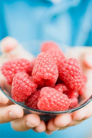 simsearch:659-01864546,k - Child's hands holding glass dish of raspberries Stock Photo - Premium Royalty-Free, Code: 659-01866284