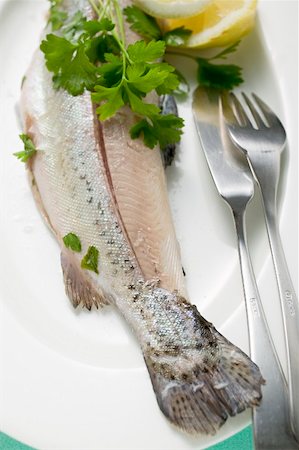 Trout with parsley and fish knife and fork on plate Stock Photo - Premium Royalty-Free, Code: 659-01866366