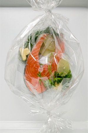 picture of fish packaging - Salmon with herbs and slices of lemon in plastic foil Stock Photo - Premium Royalty-Free, Code: 659-01866360