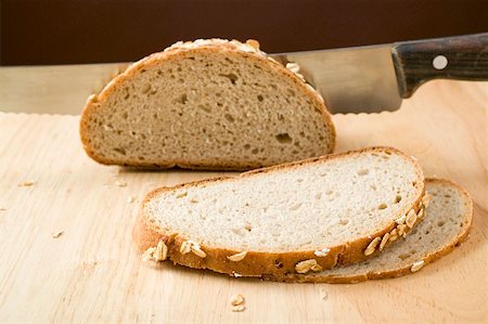 Wholemeal bread with rolled oats, partly sliced Stock Photo - Premium Royalty-Free, Code: 659-01866625