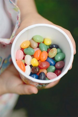 simsearch:659-01860076,k - Child's hands holding tub of coloured sugar eggs Stock Photo - Premium Royalty-Free, Code: 659-01866693