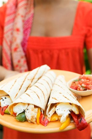 simsearch:659-03527108,k - Woman holding plate of wraps and salsa Stock Photo - Premium Royalty-Free, Code: 659-01866926