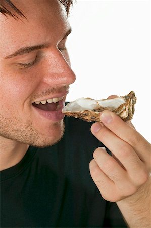 people eating seafood - Man eating a fresh oyster Stock Photo - Premium Royalty-Free, Code: 659-01867100