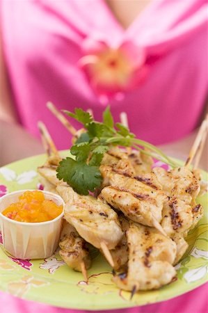 poultry skewer - Woman holding plate of satay and chutney Stock Photo - Premium Royalty-Free, Code: 659-01867115
