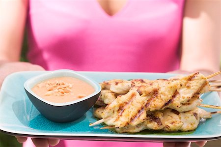 simsearch:659-01857328,k - Woman holding platter of satay and peanut dip Stock Photo - Premium Royalty-Free, Code: 659-01867113