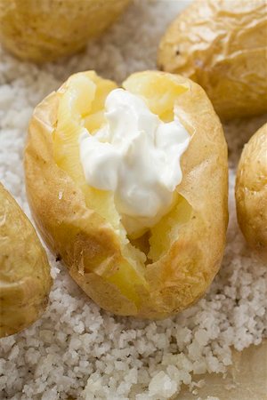 Baked potatoes with sour cream on salt Stock Photo - Premium Royalty-Free, Code: 659-01867199