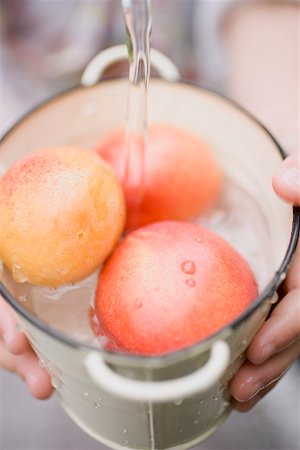 simsearch:659-01867277,k - Washing nectarines in bucket under running water Stock Photo - Premium Royalty-Free, Code: 659-01867276