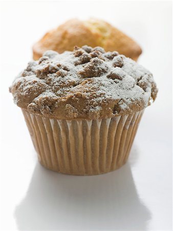 simsearch:659-01844431,k - Nut muffin sprinkled with icing sugar in front of lemon muffin Stock Photo - Premium Royalty-Free, Code: 659-01867318