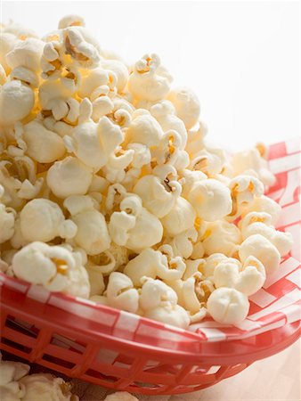 popcorn not person - Popcorn on napkin in red plastic basket Stock Photo - Premium Royalty-Free, Code: 659-01867377