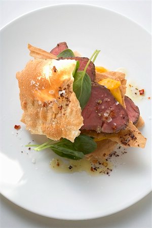 Beef fillet between sheets of pastry with basil and mango Stock Photo - Premium Royalty-Free, Code: 659-01867438