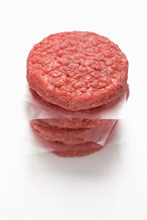 Raw burgers, in a pile Stock Photo - Premium Royalty-Free, Code: 659-01867443