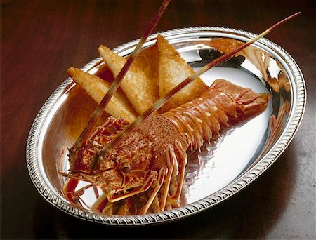 Cooked spiny lobster with toast on silver platter Fotografie stock - Premium Royalty-Free, Codice: 659-01867502