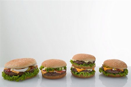 simsearch:659-01846088,k - Four cheeseburgers in a row Foto de stock - Sin royalties Premium, Código: 659-01867601