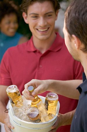 simsearch:659-03531318,k - Man serving ice-cold bottles of beer Stock Photo - Premium Royalty-Free, Code: 659-01867645