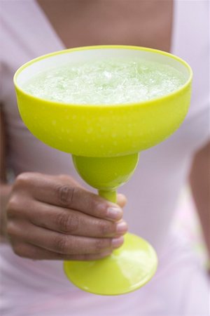 Woman holding a cocktail in a green glass Stock Photo - Premium Royalty-Free, Code: 659-01867654
