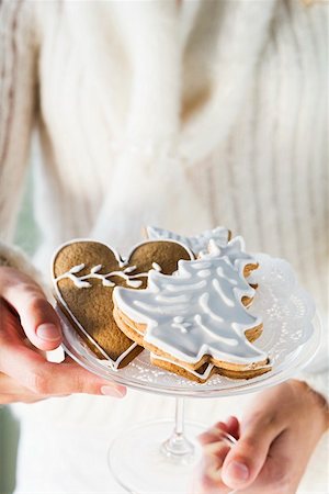 photos of christmas baking on plates - Hands holding glass bowl of assorted gingerbread biscuits Stock Photo - Premium Royalty-Free, Code: 659-01860139