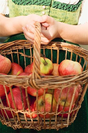 simsearch:659-06153020,k - Woman in national dress holding basket of fresh apples Stock Photo - Premium Royalty-Free, Code: 659-01860170