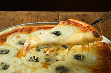 simsearch:659-01860309,k - American-style three cheese pizza with piece on server Stock Photo - Premium Royalty-Free, Code: 659-01860273