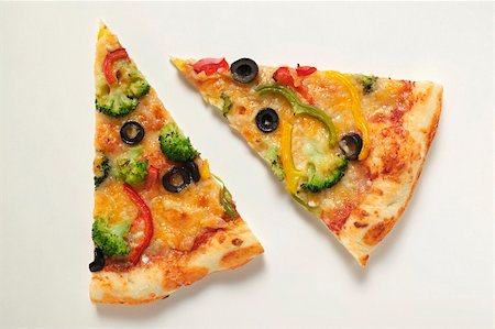 pizza from above on white - Two slices of American-style vegetable pizza Stock Photo - Premium Royalty-Free, Code: 659-01860346