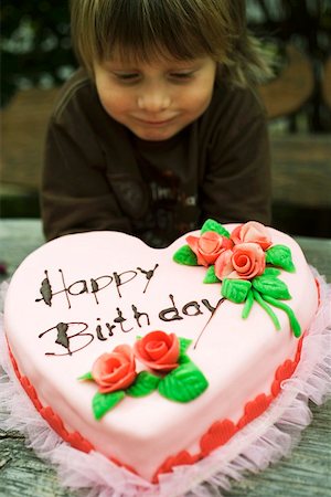 Child with pink heart-shaped birthday cake with marzipan roses Stock Photo - Premium Royalty-Free, Code: 659-01860624