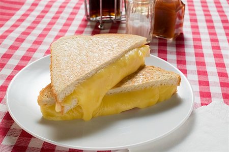 Toasted cheese sandwiches on plate, vinegar, oil, seasonings Stock Photo - Premium Royalty-Free, Code: 659-01860938