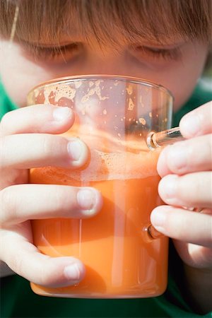 Child drinking a glass of carrot juice Stock Photo - Premium Royalty-Free, Code: 659-01861114