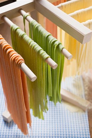 Home-made ribbon pasta, hanging up to dry Stock Photo - Premium Royalty-Free, Code: 659-01861324