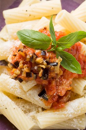 rigatoni pasta dish with tomato sauce - Rigatoni with tomato sauce, olives and Parmesan (close-up) Stock Photo - Premium Royalty-Free, Code: 659-01861358