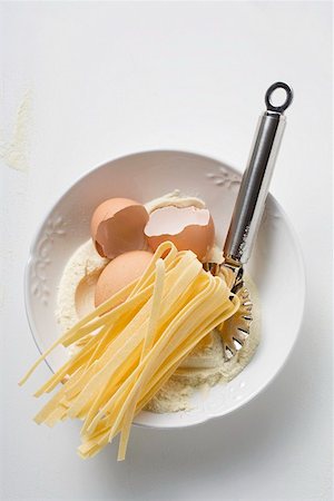 egg noodle - Home-made ribbon pasta, ingredients and pasta wheel Stock Photo - Premium Royalty-Free, Code: 659-01861352