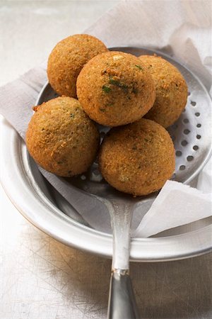 simsearch:659-08905177,k - Falafel (chick-pea balls) on slotted spoon Stock Photo - Premium Royalty-Free, Code: 659-01861425