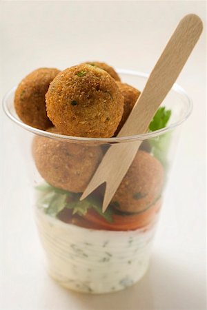 Falafel (chick-pea balls) with yoghurt sauce in beaker Stock Photo - Premium Royalty-Free, Code: 659-01861431