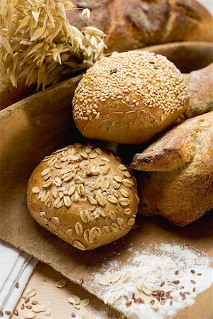 Baguettes & wholemeal rolls in wooden scoop in front of tin loaf Stock Photo - Premium Royalty-Free, Code: 659-01861609