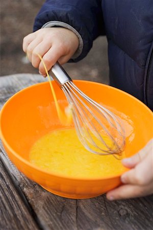 Child beating egg yolks with whisk Stock Photo - Premium Royalty-Free, Code: 659-01861737